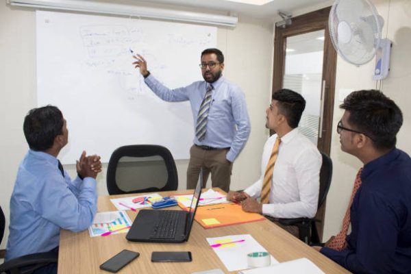 Financial analyst giving presentation to  board members